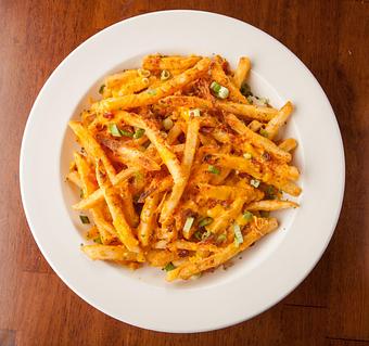 Product: Seasoned fried piled high and smothered with melted cheddar cheese, crisp bacon and chives Served with a side of ranch. - Big Whiskey's American Restaurant & Bar in Springfield, MO American Restaurants