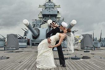 Product: Sailor dipping his wife at the Battleship, NC. Wilmington, NC - Billy Beach Photography in The Kerridor - Wilmington, NC Photography