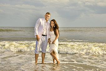 Product: Casually dressed Bride and Groom standing in the surf, sharing a moment. Oak Island, NC - Billy Beach Photography in The Kerridor - Wilmington, NC Photography