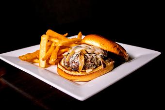 Product: Half pound fresh, grass-fed American Kobe beef burger, topped with fontina cheese, caramelized onions and roasted garlic aioli. - Black Rock Bar & Grill in Orlando, FL American Restaurants