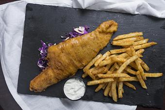 Product: Haddock, beer-battered and fried until golden brown, served with french fries and tartar sauce. - Black Rock Bar & Grill in Orlando, FL American Restaurants