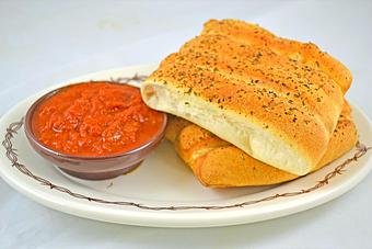 Product: Homemade breadsticks seasoned with parmesan garlic. - Buffalo Phil's Pizza & Grille in The Waterpark Capital of the World- Wisconsin Dells! - Wisconsin Dells, WI American Restaurants
