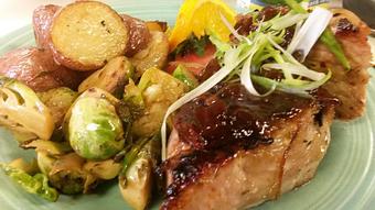 Product: Grilled pork chop with molasses b.b.q. sauce, pan seared brussel sprouts and roasted red potatoes with fresh rosemary - Buffleheads Restaurant At Hills Beach in Biddeford, ME American Restaurants