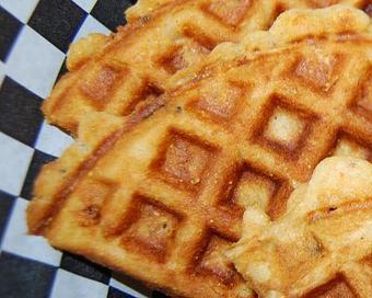 Product: Scratch made to order buttermilk waffles with jalapenos, fresh corn and cayenne pepper make this a waffle like no other. - Courson’s BBQ in Austin, TX Barbecue Restaurants