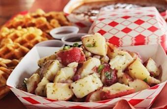 Product: Hand cut red potatoes dressed with red wine vinegar, olive oil, serrano peppers, cilantro and grilled red onions. - Courson’s BBQ in Austin, TX Barbecue Restaurants
