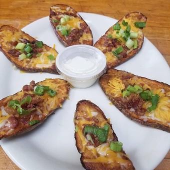 Product: 6 Slices Of deep  fried potato skin topped with shredded cheese real bacon bits and fresh Chives served with sour cream - Dabomb Sports Grill in Stonecrest area - Lithonia, GA American Restaurants