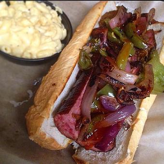 Product: Texas Choke Hold topped with grilled onions and peppers and a side of mac & cheese. - Deep Run Roadhouse in West End - Richmond, VA Barbecue Restaurants
