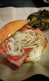 Product: Texas Rope Sausage Sandwich topped with grilled onions and a side of Collard Greens - Deep Run Roadhouse in West End - Richmond, VA Barbecue Restaurants