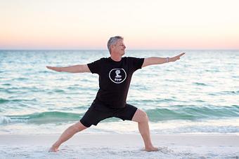 Product: John in Warrior II - Destin Hot Yoga in Across the street from the Sandestin Outlet Mall - Miramar Beach, FL Yoga Instruction