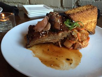 Product: slow braised baby back pork ribs, signature spice rub bbq sauce, served with napa cabbage slaw pickled ginger & cornbread - Divani in Grand Rapids, MI American Restaurants