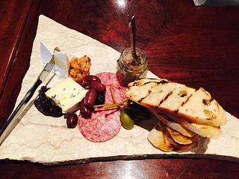 Product: Cured meats & house-made sausage, Chef’s selection of cheeses, seasonal berry compote, candied nuts, olives, grilled baguette, & gourmet crackers - Divani in Grand Rapids, MI American Restaurants