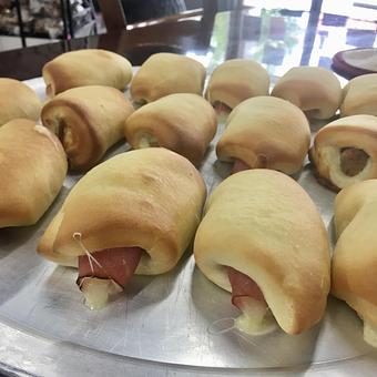 Product: Kolache! Buttery pastry dough stuffed with savory fillings. A Texas treat now available in North Wilkesboro! Perfect as a snack, appetizer, or savory breakfast item. - Dom Bakeries North Carolina in North Wilkesboro, NC Bakeries