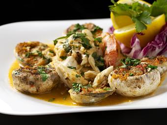 Product: shrimps, stuffed mushrooms and baked clams baked with fresh herbs and spices. - Empire Steak House in New York, NY Seafood Restaurants