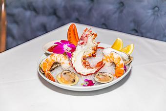 Product: fresh seafood served with lemon slices and marinara sauce. - Empire Steak House in New York, NY Seafood Restaurants