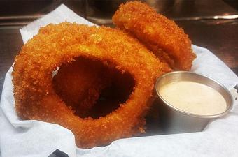 Product: Hand battered thick cut onion rings with chipotle ranch dipping sauce. 5.99 - Finnegan's Grill in Ashburn, VA American Restaurants