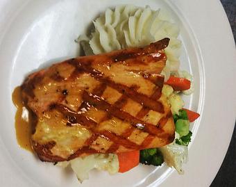 Product: Grilled salmon with an Irish whiskey glaze served with sautéed vegetables and mashed potatoes. 14.99 - Finnegan's Grill in Ashburn, VA American Restaurants