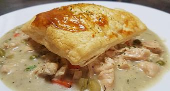 Product: Diced chicken breast and vegetables in a creamy broth served open faced with flaky puff pastry. - Finnegan's Grill in Ashburn, VA American Restaurants