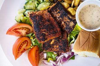 Product: Grilled blackened salmon on a fresh classic salad with tomato, cucumber, cheddar cheese, red onion and croutons. - Fisherman's Market in Whiteaker - Eugene, OR Seafood Restaurants