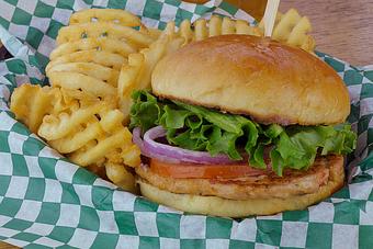 Product: Our original recipe! Freshly ground wild salmon burger on a fresh baked bun with lettuce, tomato and red onion. Served with criss-cut fries. - Fisherman's Market in Whiteaker - Eugene, OR Seafood Restaurants