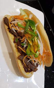 Product: Indulge in the exotic taste of freshly baked baguette topped with your choice of Ribeye, BBQ Pork, BBQ Chicken, with cilantro, carrots, daikon, jalapeno and cucumber. - Flamin' Phó & Sushi Bar in San Diego, CA Sushi Restaurants