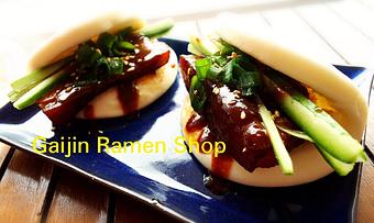 Product: Pork Buns - Served 2 Per Order
Tender braised chashu-style pork belly inside a lily-white steamed Chinese bao bun, topped with house-blended hoisin, finely chopped scallion, and cucumber. Melts-in-your mouth! - Gaijin Ramen Shop in Arlington - Arlington, VA Pasta & Rice