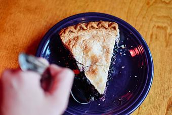 Product: Geddy's delicious homemade blueberry pie, served cold with whipped cream or warm a la mode. - Geddy's in Downtown Bar Harbor, just steps from the town pier. - Bar Harbor, ME American Restaurants