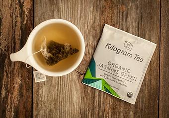 Product: An organic China green tea scented with jasmine blossoms in an amply sized pyramid bag to ensure that the flavors end up in the cup, not tossed out with the bag. - Harold's Coffee Lounge in Northwood - West Palm Beach, FL Coffee, Espresso & Tea House Restaurants