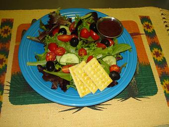 Product: Organic spring greens, english cucumber, cherry tomatoes and black olives. - Hillsboro General Store in Hillsboro New Mexico Historical District - Hillsboro, NM American Restaurants