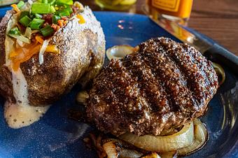 Product: Chopped Steak (certified angus beef) over a bed of sauteed onions with your choice of side - Hoffbrau Steak & Grill House in Granbury, TX American Restaurants