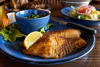 Product: Pan-Seared Tilapia with steamed spinach - Hoffbrau Steak & Grill House in Granbury, TX American Restaurants