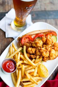 Product: Fried Cajun shrimp dressed with seasoned mayo, lettuce, fresh pickles, and tomatoes on Leidenheimer's French bread - House of Blues Restaurant & Bar in Anaheim, CA Restaurants/Food & Dining