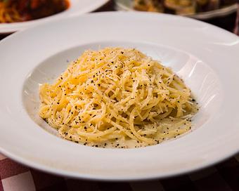 Product: a roman classic. bucatini tossed with pecorino and parmesan cheese, finished with 17.5 cracks of multi-color peppercorn - Il Porcellino in River North - Chicago, IL Italian Restaurants