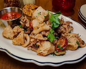 Product: tender rhode island calamari served crispy with zesty cherry peppers and spicy marinara sauce - Il Porcellino in River North - Chicago, IL Italian Restaurants