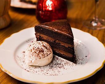 Product: chocolate cake layered with chocolate ganache and finished with a chocolate glaze. served with freshly whipped cream - Il Porcellino in River North - Chicago, IL Italian Restaurants