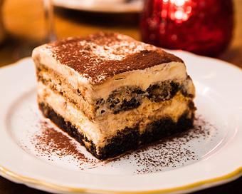 Product: coffee soaked lady fingers layered high with whipped mascarpone, and finished with cocoa powder - Il Porcellino in River North - Chicago, IL Italian Restaurants