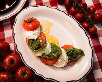Product: local mighty vine tomatoes served with imported creamy buffalo mozzarella cheese, fresh basil, and olive oil - Il Porcellino in River North - Chicago, IL Italian Restaurants
