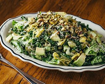 Product: fresh kale with poblano peppers, fennel, avocado, olives, brussels sprouts, pepperoncini, toasted pistachios, parmesan cheese, and chili flakes, served with a bright red wine vinaigrette - Il Porcellino in River North - Chicago, IL Italian Restaurants