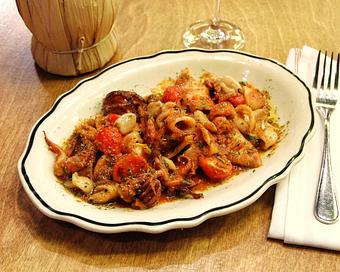 Product: tender rhode island calamari marinated in fresh herbs and grilled, tossed in a calabrian chili tomato sauce, fresh cherry tomatoes, and oven-roasted garlic - Il Porcellino in River North - Chicago, IL Italian Restaurants