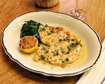 Product: thinly pounded free-bird chicken breast sauteed with a class piccata sauce and served with garlic spinach - Il Porcellino in River North - Chicago, IL Italian Restaurants