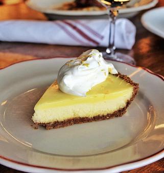 Product: light and airy cheesecake, in a graham cracker crust, topped with a zesty lemon curd, and finished with freshly whipped cream - Il Porcellino in River North - Chicago, IL Italian Restaurants
