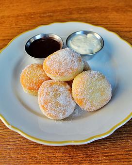 Product: freshly fried brioche donuts tossed in vanilla sugar and served with whipped mascarpone and whipped nutella - Il Porcellino in River North - Chicago, IL Italian Restaurants