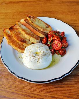Product: creamy and rich di stefano burrata is served with oven roasted tomatoes, and freshly baked olive oil and sea-salt crostini - Il Porcellino in River North - Chicago, IL Italian Restaurants