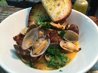 Product: Clams w kale + cider broth - Jeninni Kitchen + Wine Bar in pacific grove - Pacific Grove, CA Bars & Grills
