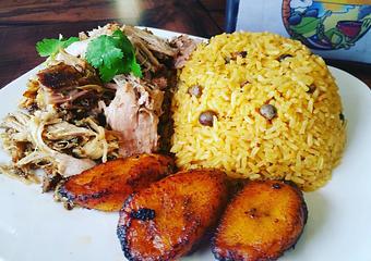 Product: Pernil (Roasted Pork) arroz con gandules y maduros - Joe's Caribe Restaurant and Bakery in Scenic Heights - Pensacola, FL Caribbean Restaurants