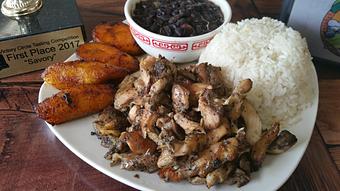 Product: Jerk Chicken Plate with white rice, black beans, y maduros - Joe's Caribe Restaurant and Bakery in Scenic Heights - Pensacola, FL Caribbean Restaurants