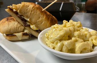 Product: Mac N Cheese with a Truffle Steak Sandwich hiding in the background. - John A's in Nashville, TN Bars & Grills