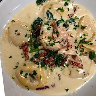 Product: Carbonara Ravioli di Pesce - Seafood ravioli with shrimp, fresh spinach and sundried tomatoes in a garlic, pancetta, cheese cream sauce - La Trattoria Restaurant in Old Town - Key West, FL Bars & Grills