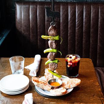 Product: Beef Tenderloin TORO Skewer served with our Catalan tomato bread and mojo picón sauce - Lil’ Ba-Ba-Reeba! in River North - Chicago, IL Bars & Grills