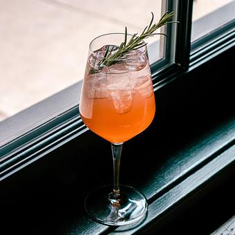Product: pomegranate, bonanto, rosemary simple, aperol & sparkling cava - Lil’ Ba-Ba-Reeba! in River North - Chicago, IL Bars & Grills