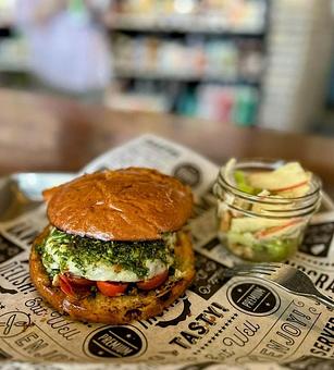 Product: Highland Spring Farm grass-fed beef*, chimichurri sauce, roasted cherry tomato, Wisconsin pepper jack cheese on a Clasen brioche bun - Longtable Beer Cafe in Downtown Middleton - Middleton, WI American Restaurants